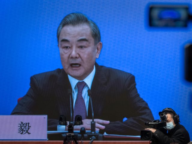 BEIJING, CHINA - MARCH 07: China's Foreign Minister Wang Yi, on screen, answers a question