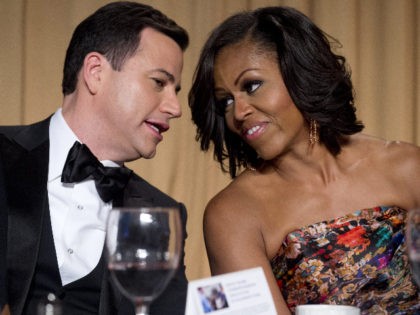 Television host Jimmy Kimmel (L) sits alongside First Lady Michelle Obama (R) during the W