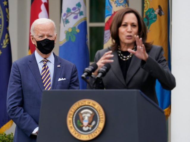 President Joe Biden listens as Vice President Kamala Harris speaks about the American Rescue Plan, a coronavirus relief package, in the Rose Garden of the White House, Friday, March 12, 2021, in Washington. (AP Photo/Alex Brandon)