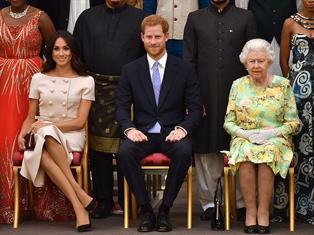 LONDON, ENGLAND - JUNE 26: Meghan, Duchess of Sussex, Prince Harry, Duke of Sussex and Queen Elizabeth II at the Queen's Young Leaders Awards Ceremony at Buckingham Palace on June 26, 2018 in London, England. The Queen's Young Leaders Programme, now in its fourth and final year, celebrates the achievements …