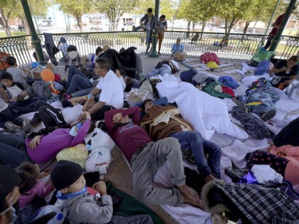 A group of migrants rest on a gazebo at a park after the deportees from the U.S. were pushed by Mexican authorities off an area they had been staying after their expulsion, Saturday, March 20, 2021, in Reynosa, Mexico. (Julio Cortez/AP Photo)
