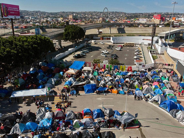 Aerial view of a migrants camp where asylum seekers wait for US authorities to allow them to start their migration process outside El Chaparral crossing port in Tijuana, Baja California state, Mexico on March 17, 2021. - President Biden's pledge of a more humane approach has sparked a new rush …