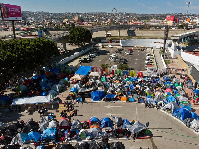 Aerial view of a migrants camp where asylum seekers wait for US authorities to allow them to start their migration process outside El Chaparral crossing port in Tijuana, Baja California state, Mexico on March 17, 2021. - President Biden's pledge of a more humane approach has sparked a new rush to the border, threatening to become a huge political liability. Republicans are accusing him of opening the country's doors to illegal border-crossers and sparking a "crisis" on the US-Mexico frontier, while migrants out of Migrant Protection Protocols (MPP) program are stranded along the US-Mexico border without knowing when or how they will be able to start their migratory process with US authorities. (Photo by Guillermo Arias / AFP) (Photo by GUILLERMO ARIAS/AFP via Getty Images)