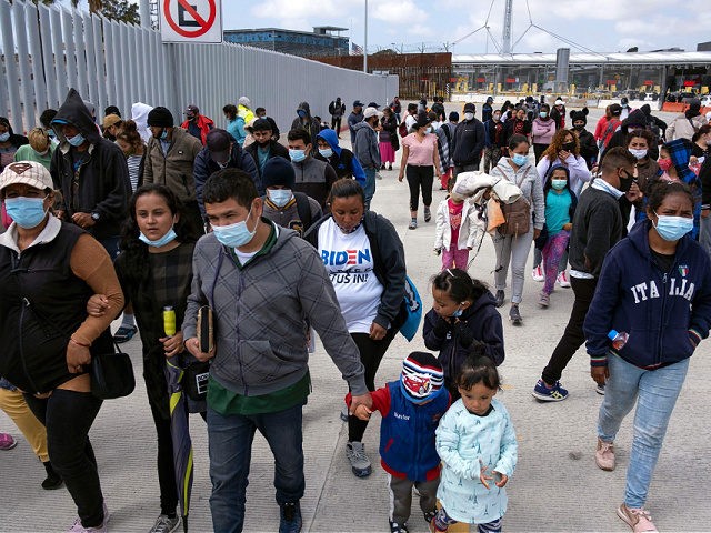 Migrants and asylum seekers awl after a demonstration at the San Ysidro crossing port asking US authorities to allow them to start their migration process in Tijuana, Baja California state, Mexico on March 23, 2021. - Migrants out of MPP program are stranded along the US-Mexico border without knowing when …