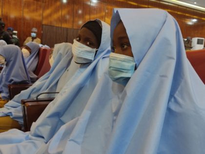 TOPSHOT - A group of girls previously kidnapped from their boarding school in northern Nigeria are seen on March 2, 2021 at the Government House in Gusau, Zamfara State upon their release. - All 279 girls kidnapped from their boarding school in northern Nigeria have been released and are on …