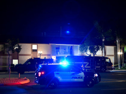 Police officers stand outside a building were multiple people were killed in a shooting in Orange, California on March 31, 2021. - Metro City Fire Autority Dispatch said that four people were dead and two others had been transported to local hospitals. The suspect is in custody and was also …