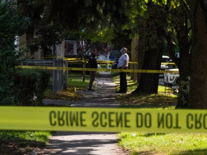 ROCHESTER, NY - SEPTEMBER 19: Police officers investigate a crime scene after a shooting at a backyard party on September 19, 2020, Rochester, New York. Two young adults - a man and a woman - were reportedly killed, and 14 people were injured in the shooting early Saturday morning on …