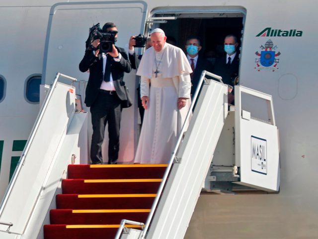 Pope Francis looks on as he bids farewell to his hosts before boarding his Alitalia Airbus A330 aircraft as he departs from the Iraqi capital's Baghdad International Airport on March 8, 2021. (Photo by Ahmad AL-RUBAYE / AFP) (Photo by AHMAD AL-RUBAYE/AFP via Getty Images)