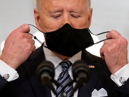 President Joe Biden takes off his mask to speak about the COVID-19 pandemic during a prime