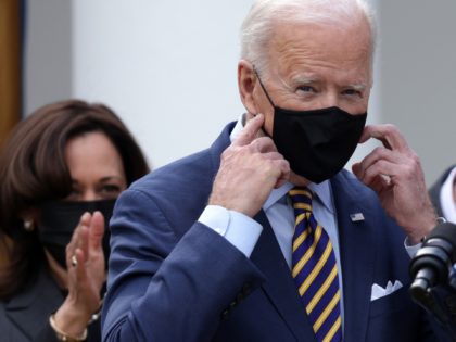 WASHINGTON, DC - MARCH 12: U.S. President Joe Biden (R) takes off his mask as Vice President Kamala Harris (L) looks on during an event on the American Rescue Plan in the Rose Garden of the White House on March 12, 2021 in Washington, DC. President Biden signed the $1.9 …