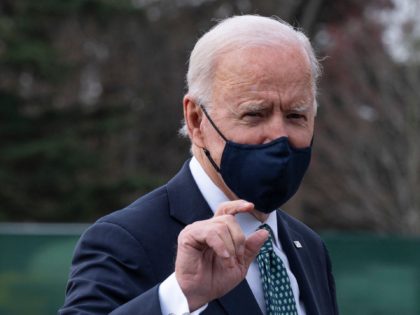 US President Joe Biden gestures as he walks off Marine One upon his arrival at the White H