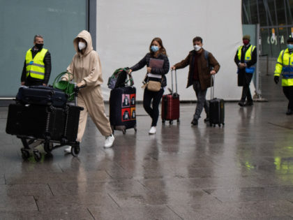 LONDON, ENGLAND - FEBRUARY 15: Passengers arriving at Heathrow's Terminal 5 are escorted b