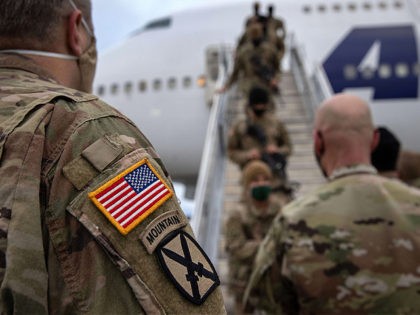 FORT DRUM, NEW YORK - DECEMBER 10: U.S. Army soldiers return home from a 9-month deployment to Afghanistan on December 10, 2020 at Fort Drum, New York. The 10th Mountain Division soldiers who arrived this week are under orders to isolate at home or in barracks, finishing their Covid-19 quarantine …