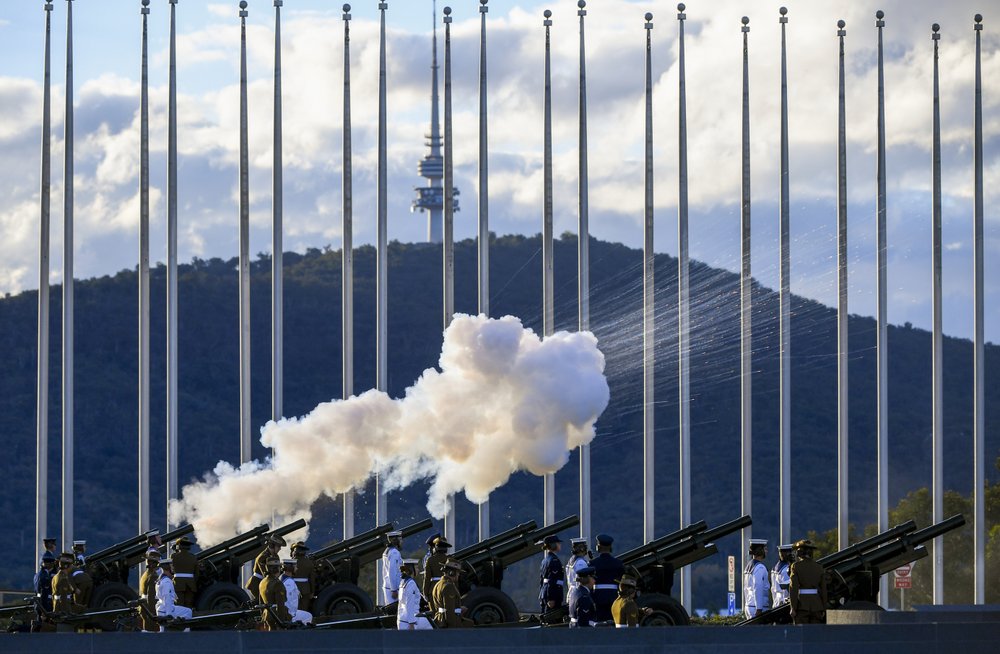 The Australian Federation Guard fire a 41 gun salute to mark the passing of Prince Philip on the forecourt of Parliament House, in Canberra, Australia, Saturday, April 10, 2021. Prince Philip, the irascible and tough-minded husband of Queen Elizabeth II who spent more than seven decades supporting his wife in a role that mostly defined his life, has died, Buckingham Palace said Friday, April 9. He was 99. (Lukas Coch/AAP Image via AP)