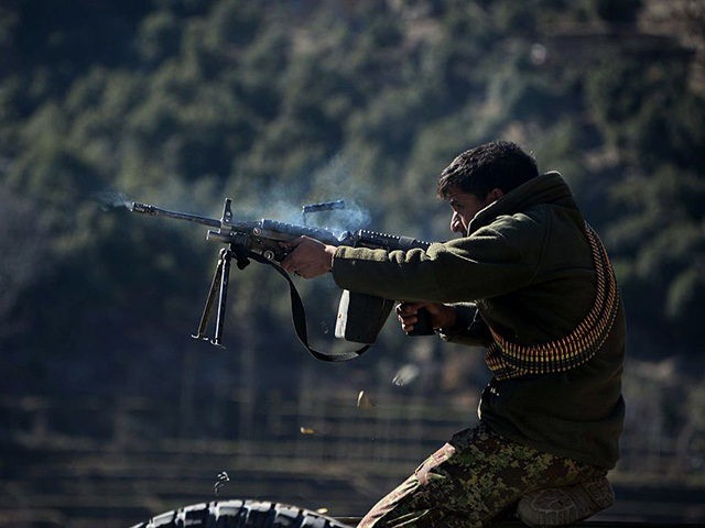 An Afghan National Army (ANA) soldier fires a rifle during an ongoing anti-Taliban operati