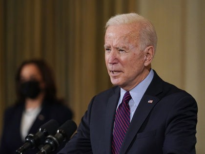 President Joe Biden, accompanied by Vice President Kamala Harris, speaks about the economy in the State Dinning Room of the White House, Friday, Feb. 5, 2021, in Washington. (AP Photo/Alex Brandon)