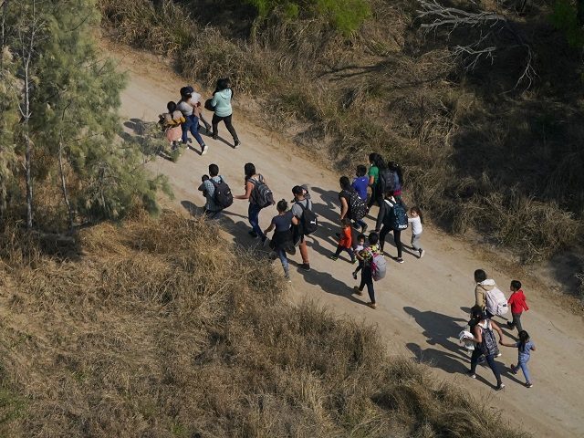 Migrants walk on a dirt road after crossing the U.S.-Mexico border, Tuesday, March 23, 2021, in Mission, Texas. A surge of migrants on the Southwest border has the Biden administration on the defensive. The head of Homeland Security acknowledged the severity of the problem but insisted it's under control and …