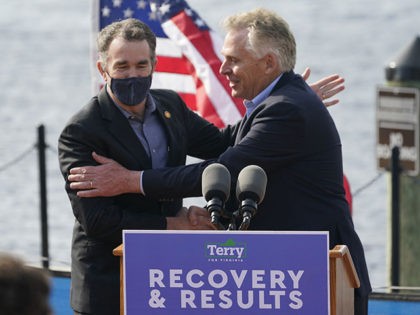 Virginia Gov. Ralph Northam, left, greets former Gov. and Democratic gubernatorial candidate, Terry McAuliffe, right, during a news conference at Waterside in Norfolk, Va., Thursday, April 8, 2021. Northam endorsed McAuliffe for Governor. (AP Photo/Steve Helber)