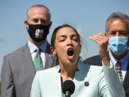 Representative Alexandria Ocasio-Cortez(D-NY) next to Senator Ed Markey(R), D-MA, speaks d