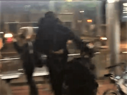 An Antifa rioter punches a police officer in the face on April 20. (Twitter Video Screencapture/The Oregonian)