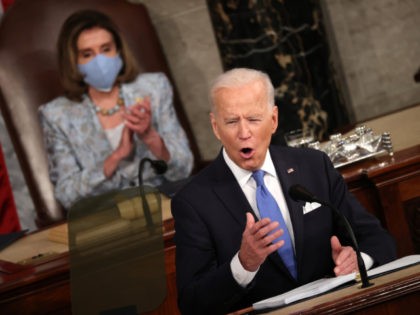 WASHINGTON, DC - APRIL 28: U.S. President Joe Biden addresses a joint session of congress as Speaker of the House U.S. Rep. Nancy Pelosi (D-CA) (L) looks on in the House chamber of the U.S. Capitol April 28, 2021 in Washington, DC. On the eve of his 100th day in …