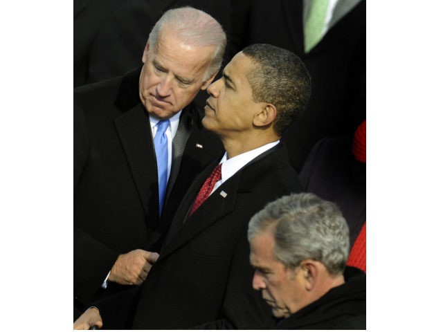 US President Barack Obama (R) and Vice President Joe Biden speak during Obama's inauguration as the 44th US president at the Capitol in Washington on January 20, 2009 as former US president George W. Bush looks on below. AFP PHOTO/ TIMOTHY A. CLARY (Photo credit should read TIMOTHY A. CLARY/AFP …