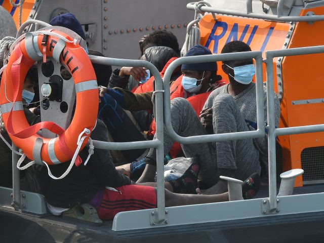 Migrants picked up at sea whilst crossing the English Channel are brought into the Marina