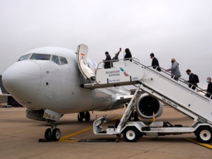 Invited passengers board an American Airlines Boeing 737 Max jet before departing from Dallas Fort Worth airport in Grapevine, Texas, Wednesday, Dec. 2, 2020. American Airlines took its long-grounded Boeing 737 Max jets out of storage, updating key flight-control software, and flying the planes in preparation for the first flights …