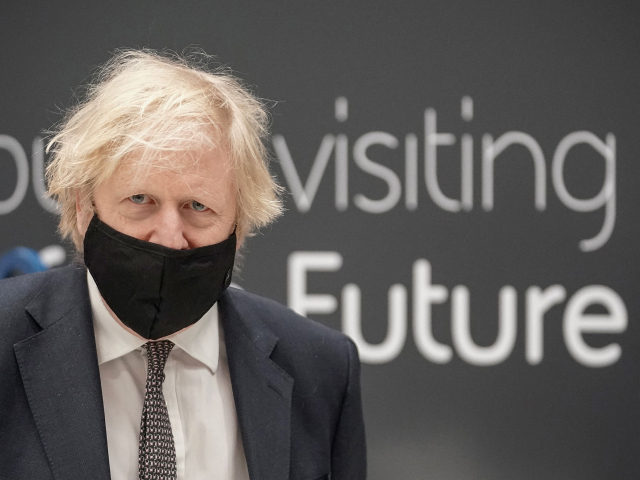 Britain's prime minister Boris Johnson wearing a mask because of the coronavirus pandemic visits BAE Systems at Warton Aerodrome in Preston, northwest England, on March 22, 2021. - The prime minister's visit comes to mark the publication of the UK government's Integrated Review, an overhaul of Britain's security, defence and …