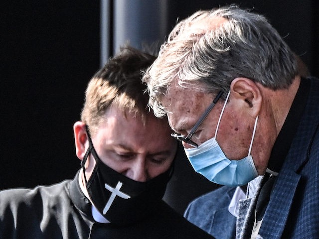 Australian Cardinal George Pell (R) gets into a car after landing at Rome's Fiumicino airp