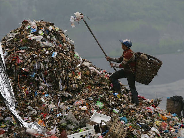 A scavenger picks up plastic bags at an open dump on April 2, 2008 in Chongqing Municipality, China. The Chinese government has announced a nationwide ban on stores distributing free ultra-thin plastic bags from June 1, 2008. The new rule says all retailers have to clearly indicate the price of …