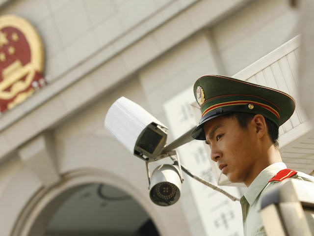 A Chinese paramilitary policeman stands guard outside Beijing's No. 2 Intermediate Court w