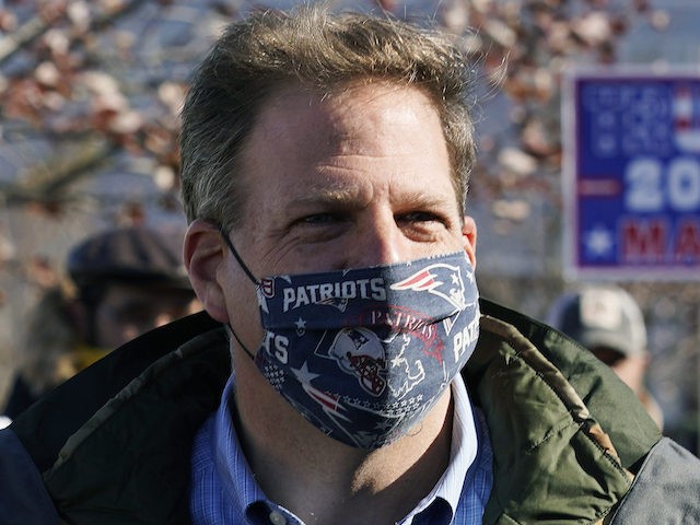 FILE— In this Nov. 3, 2020 file photograph, N.H. Gov. Chris Sununu wears a protective mask, due to the COVID-19 virus outbreak, at a polling station in Windham, N.H. New Hampshire on joined three dozen other states, including the rest of New England, in enacting a statewide mask mandate as …
