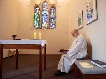 Prior of Lough Derg, Father Laurence (La) Flynn prays inside St Mary's Chapel at St. Patrick's Purgatory on Lough Derg, currently closed to visitors due to the COVID-19 pandemic, near Donegal in Ireland, on July 27, 2020. - As people in Ireland endured months of coronavirus lockdown limbo, priest Laurence …