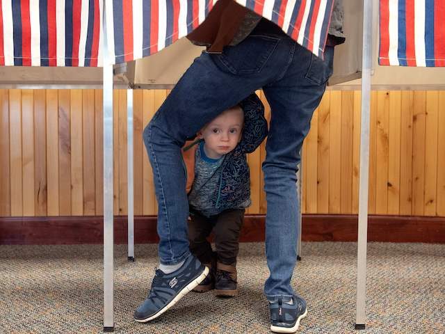 Two-year-old Noah Davenport of Granby, Colorado, waits for his mother to cast her ballot at the Granby Town Hall on November 3, 2020. - Americans were voting on Tuesday under the shadow of a surging coronavirus pandemic to decide whether to reelect Republican Donald Trump, one of the most polarizing …