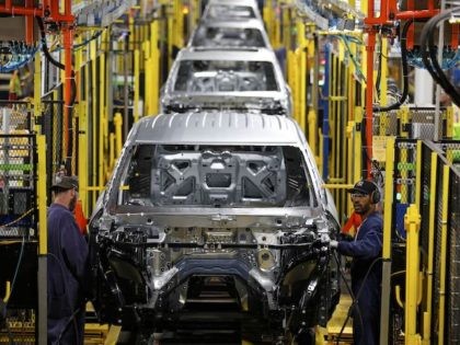 Workers assemble cars at the newly renovated Ford's Assembly Plant in Chicago, June 24, 20