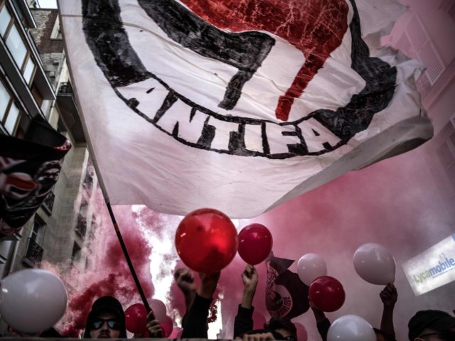 Demonstrators hold a banner and balloons as they stage a protest in Paris on September 14, 2018, co-inciding with the end of the trial of three men accused of killing the late anti-fascist protestor Clement Meric in a clash in 2013. (Photo by Christophe ARCHAMBAULT / AFP) (Photo credit should …