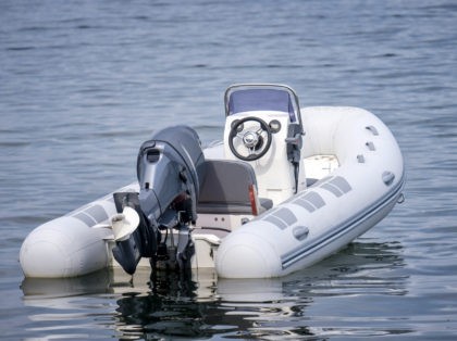 Inflatable White Motor Boat Floating At Sea