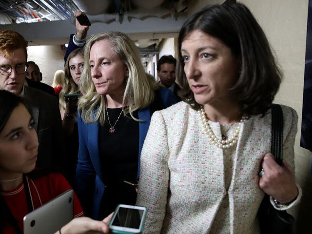 WASHINGTON, DC - SEPTEMBER 24: Rep. Abigail Spanberger (C) (D-VA) and Rep. Elaine Luria (R) (D-VA) are trailed by reporters after leaving a House Democratic caucus meeting at the U.S. Capitol where formal impeachment proceedings against U.S. President Donald Trump were announced by Speaker of the House Nancy Pelosi September …