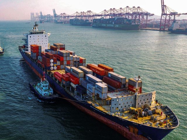 A cargo ship loaded with containers makes its way at a port in Qingdao in China's eastern Shandong province on January 14, 2020. (STR/AFP via Getty Images)