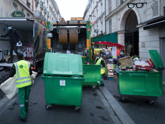 Rubbish collectors of the Paris municipality cleaning service "Proprete de Paris", wearing face masks, collect waste bins to be emptied in a garbage truck in Paris on April 30 , 2020 as France is under lockdown to stop the spread of the COVID-19 pandemic, caused by the novel coronavirus. (Photo …