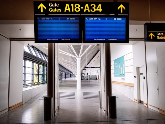 A picture taken on May 15, 2020 shows empty screens at almost empty Copenhagen Airport, am