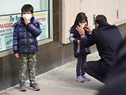 NEW YORK, NEW YORK - APRIL 05: A man adjusts a child's protective mask amid the coronavirus pandemic on April 05, 2020 in New York City. COVID-19 has spread to most countries around the world, claiming almost 70,000 lives with infections nearing 1.3 million people. (Photo by Cindy Ord/Getty Images)