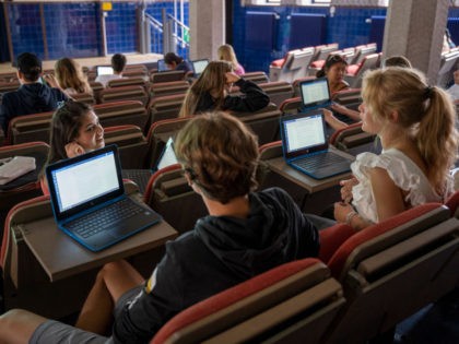 STOCKHOLM, SWEDEN - AUGUST 21: Students, advised to respect social distancing rules, attend history class on the first day back to school since the March shut down, on August 21, 2020 in Stockholm, Sweden. The high school will continue a majority of the education online, with physical classes programmed every …