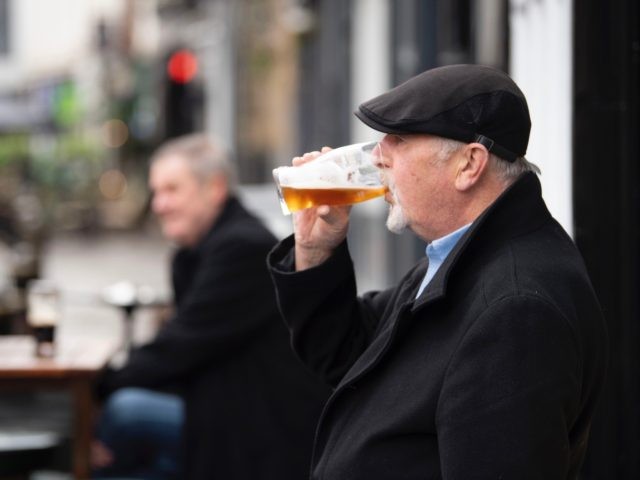 CARDIFF, WALES - OCTOBER 23: A man drinks a pint outside the Goat Major pub on October 23, 2020 in Cardiff, Wales. Wales will go into a national lockdown from Friday until November 9. People will be told to stay at home and pubs, restaurants, hotels and non-essential shops must …