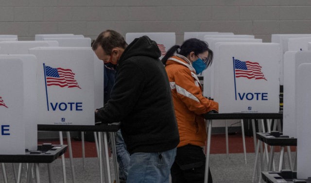 TOPSHOT - Residents cast their votes on November 3, 2020, at Mott Community College in Flint, Michigan. (Photo by Seth Herald / AFP) (Photo by SETH HERALD/AFP via Getty Images)