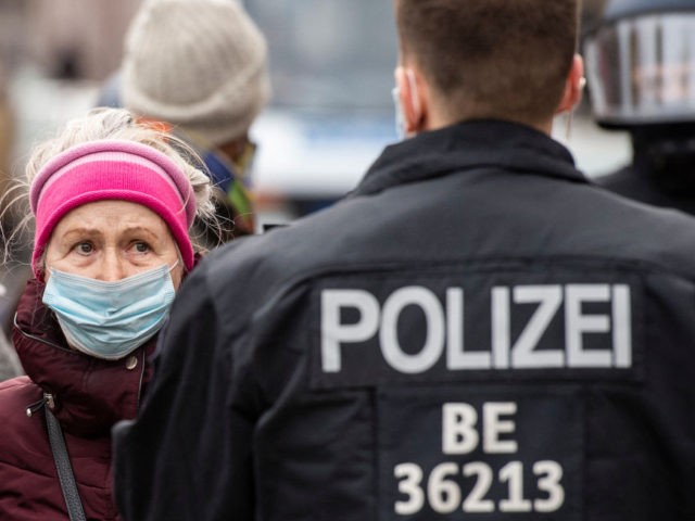 A woman protesting against anti-Coronavirus measures confronts a police officer during a protest in Berlin on March 28, 2021, amid a Coronavirus (Covid-19) pandemic. (Photo by John MACDOUGALL / AFP) (Photo by JOHN MACDOUGALL/AFP via Getty Images)