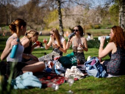 People enjoy the sunshine in St James's Park, central London on March 30, 2021, as England