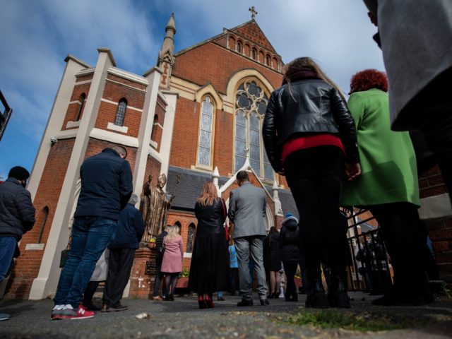 LONDON, ENGLAND - APRIL 04: Christians stand outside during an Easter Sunday service due to lack of space indoors because of covid-19 social distancing guidelines at Christ the King church on April 4, 2021 in the Balham area of London, England. The church had its Good Friday service interrupted by …