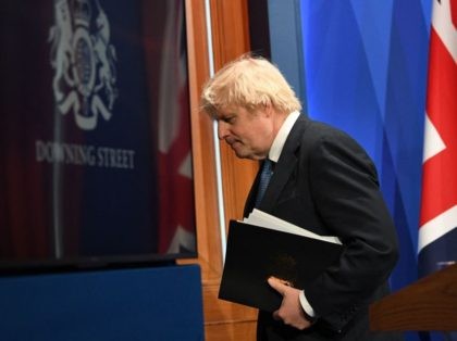 Britain's Prime Minister Boris Johnson leaves after giving an update on the coronavirus Covid-19 pandemic during a virtual press conference inside the new Downing Street Briefing Room in central London on April 5, 2021. - Britain on Monday will unveil plans to restart international travel as it cautiously exits a …